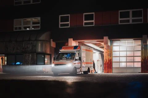 Fire station at night with fire trucks responding to emergency call and leaving Stock Photos