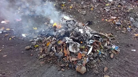 The fire that is still burning from the rest of the burning garbage Stock Footage 219728206
