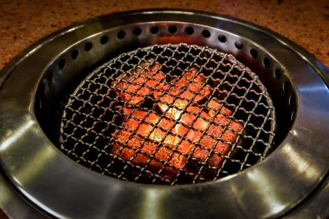 Fire in stove ready for BBQ at table Stock Photos