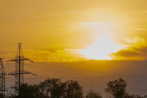 Fire sunset in cloud. Shape of high voltage pole and electric lines with fire Stock-Fotos