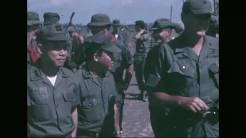 FIRE SUPPORT BASE DANGER - 1969: ARVN turnover ceremony — the US flag flying Stock Footage 341698231