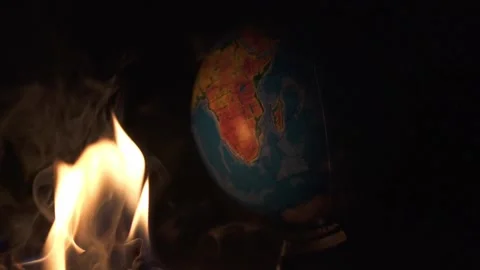 Fire takes an earth globe on cement shapes of abandoned building Video stock 152739685