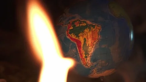 Fire takes an earth globe on cement shapes of abandoned building Stock Footage 152795539