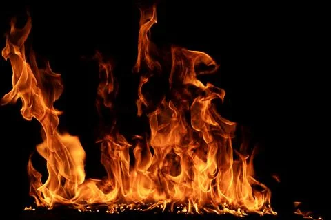 Fire texture with fiery flames. Fire blaze rising on black. Fire burning in.. Stock Photos