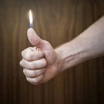 Fire on thumbs Stock Photos