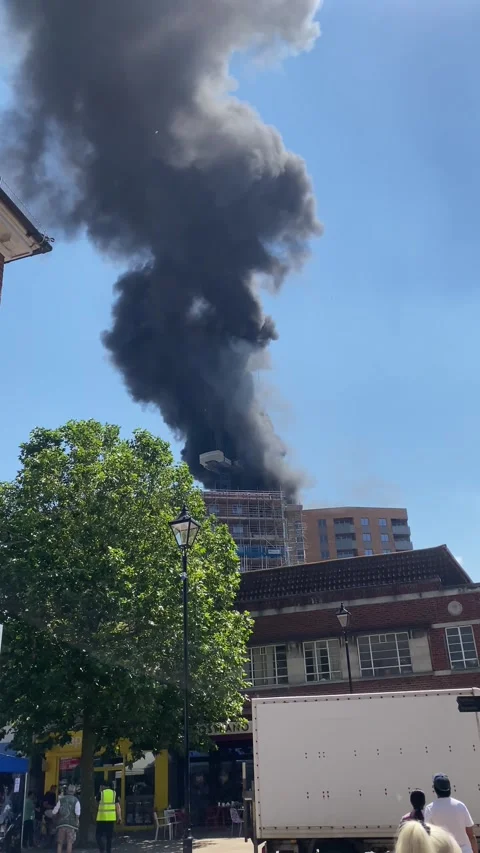 A fire at the top of a newly built tower block in Staines, UK Stock Footage 278179547