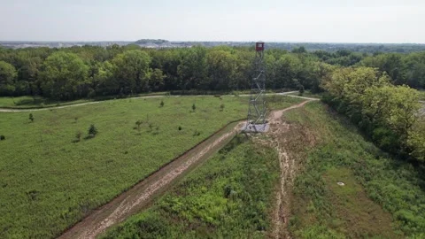 Fire tower in grass field overlooks safety in metro park Stock Footage 282811840