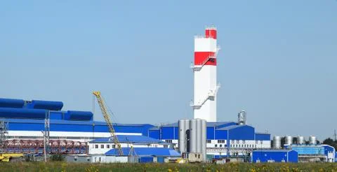 Fire tower at the plant for the processing of scrap metal. Huge factory old m Stock Photos