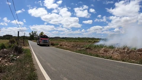 Fire Truck Approaching a Fire Scene in a Grassfield Stock Footage 218254460