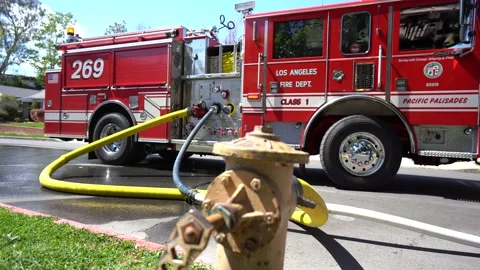 fire truck connected to fire hydrant