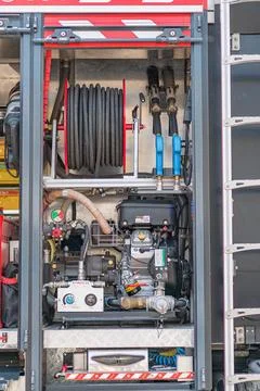 Fire truck interior, engine compartment with hoses, pipes, connections, coate Stock Photos