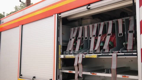 Fire truck, open side of van, fire hoses, fire extinguishing hoses, and fire 库存影片 200981157