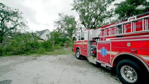 Fire truck parked in front of fallen trees and debris from Hurrican Irma Stock Footage 80361254