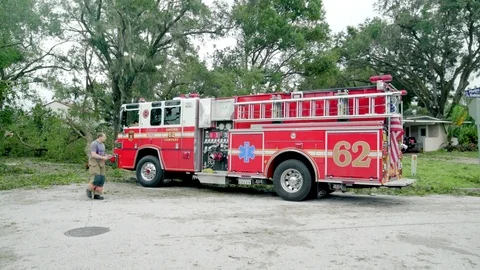 Fire truck pulls tree out of street after Hurricane Irma Stock Footage 80340235