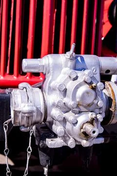 Fire truck water pump attached to a red vehicle, showcasing detailed engineering Stock Photos