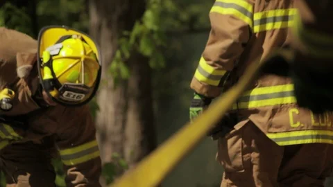 Fire Trucks and Fire Department with hoses and tools - Staged Portrayal Stock Footage 103824580