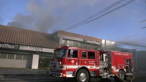 Fire trucks fighting building fire Stock Footage 171267770
