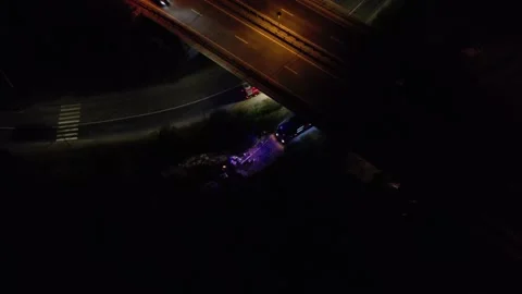 Fire trucks fire hose preparing to extinguish a fire at night under the bridge C Видео 158051180