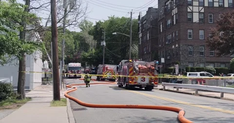 Fire trucks / firefighter blocks the road to put fire out, Fort Lee Road, Leonia Stock Footage 240964545