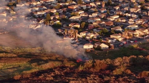 Fire Trucks Line the Street as Flames Reach Backyard Fences, Aerial View 動画素材 341840227