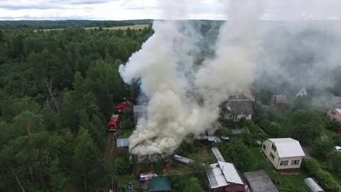 Fire trucks next to a burning house. Aerial view. Stock Footage 74849933