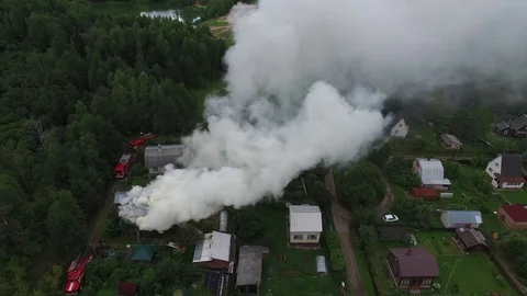 Fire trucks next to a burning house. Aerial view. Stock-Footage 74853049