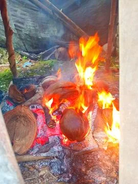 Fire used to smoke coconuts to make copra Stock Photos