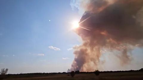 Fire, view from a moving car - a huge column of smoke in the rays of the sun Stock Footage 315339557