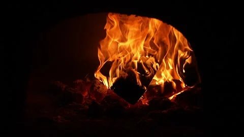 Fire Warms Surroundings. Crackling Flames Cast Inviting Glow Stock Footage 328496657