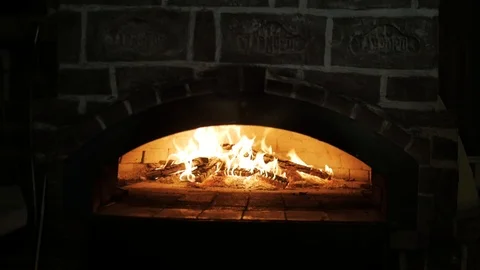 Fire in wood fired stone oven. Fast food cooked in a wood-fired oven. Stock Footage 107601088