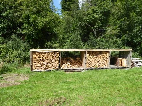 Fire wood piles in shed Stock Photos