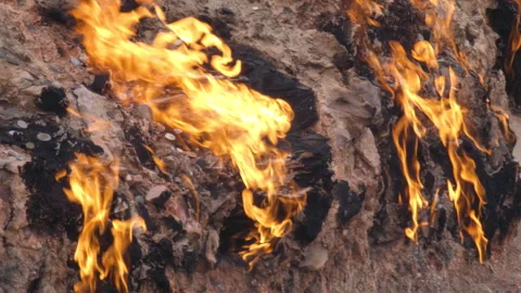 Fire in Yanar Dagh, Azerbaijan - perpetually burning mountain, natural gas flame Stock Footage 322096935