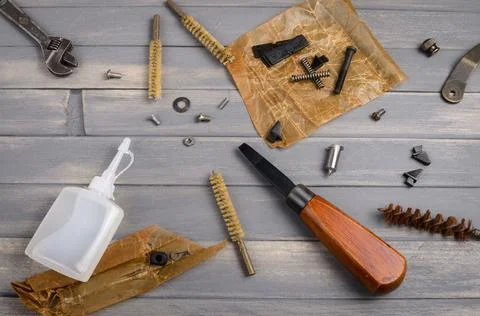 Firearm cleaning tool kit: brushes, handles, machine oil, oiled paper Stock Photos