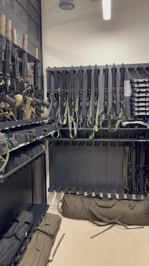 Firearms stored on racks inside secure armory Video stock 327072068