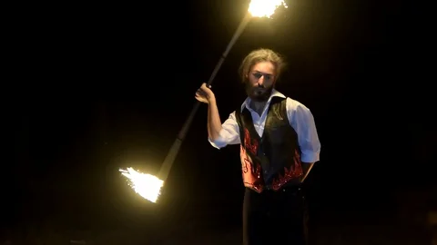 Fireartist performs firejuggling at fireshow Stock Footage 128971792
