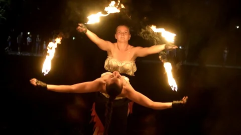 Fireartists perfom a fireshow at night Stock Footage 128958904