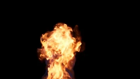Fireball in center frame fueled from below on black BG Stock Footage 77134342