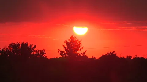 Fireball red sunset due to smoke filtering from distant forest fires Stock Footage 40438708
