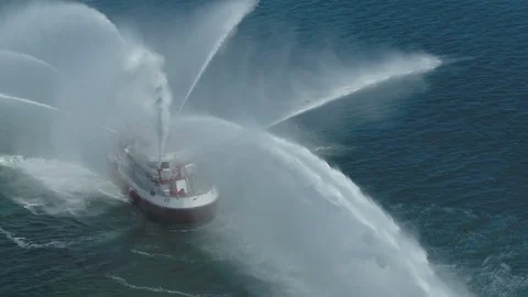Fireboat Protector doing water gun tests in open water Video stock 116490138