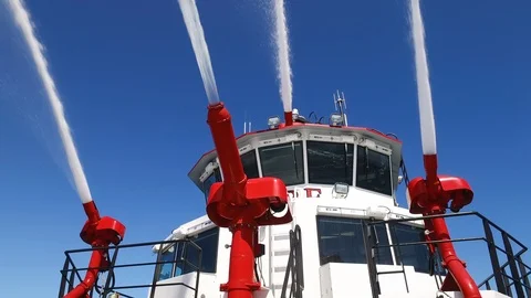 Fireboat Protector doing water gun test in the sea Stock Footage 116496347