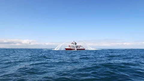 Fireboat Protector doing water gun test in the sea Stock Footage 116496440
