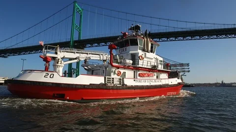 Fireboat Protector sailing under the bridge on Port of Long Beach Stock Footage 116495857