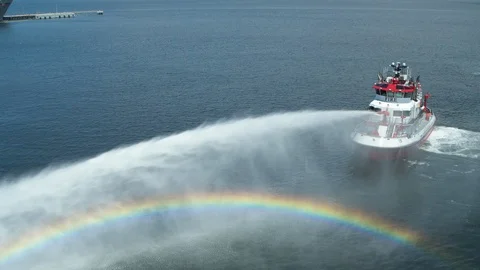 Fireboat Vigilance rotate while shooting out water 
creating rainbow Stock Footage 116478693