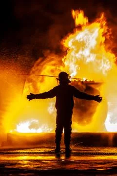 Firechief with arms open in front of fire Stock Photos