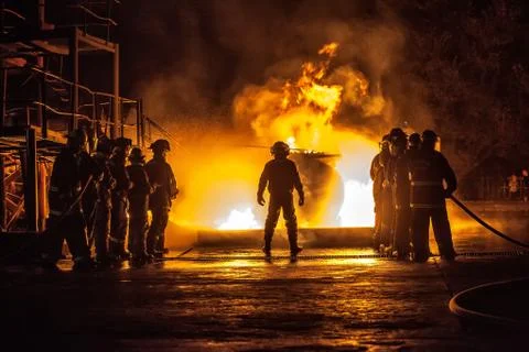 Firechief controlling two teams fighting a fire Stock Photos