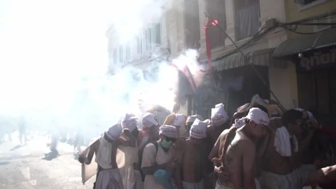 Firecracker explosions during the Phuket vegetarian festival. Stock Footage 261954588
