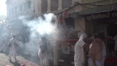 Firecracker explosions during the Phuket vegetarian festival. Stock Footage 261956484