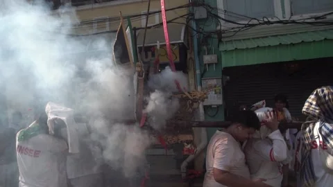 Firecracker explosions during the Phuket vegetarian festival. Stock Footage 261957185