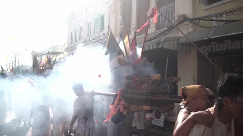 Firecracker explosions during the Phuket vegetarian festival. Stock Footage 261958346