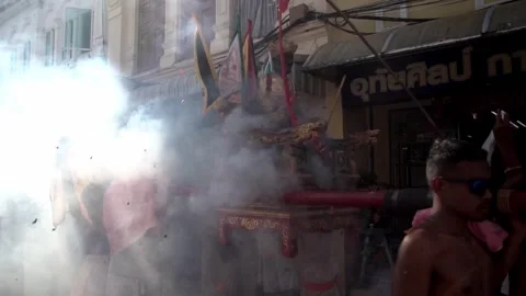 Firecracker explosions during the Phuket vegetarian festival. Stock Footage 261959346